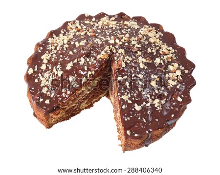 glazed cake sprinkled with nuts isolated with piece cut out on white background. Side view.