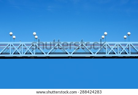 Fragment of bridges with lamps in blue sky background, architectural fragment, blue bridge, architecture detail 