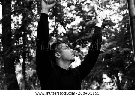 Man photographed in street workout session.Photo was taken in early morning, around 6am in city park Dudova forest. Black and white photo.
