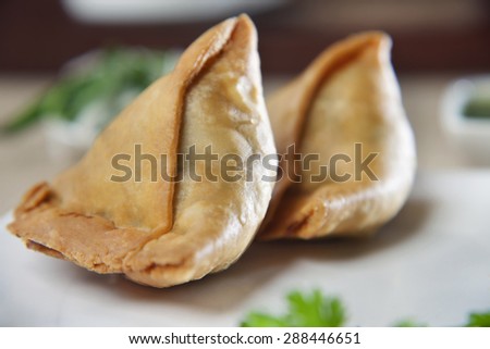 Close-up of two samosas in plate