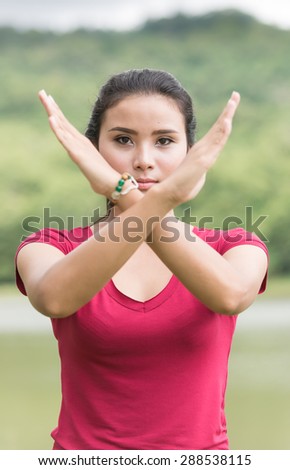 young asian woman making stop desture