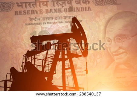 Oil pump on background of indian rupie