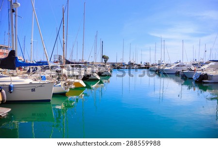 Photo of incredible beauty Harbor Yacht Club with glazed clear sea and blue clouds. Italy. Nettuno.