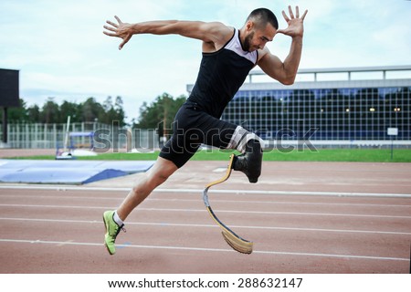 Explosive start of athlete with handicap at the stadium Royalty-Free Stock Photo #288632147
