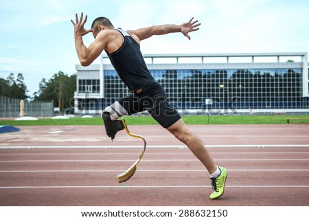 Explosive start of athlete with handicap at the stadium Royalty-Free Stock Photo #288632150