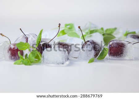 cherry and ice cubes with mint leaves