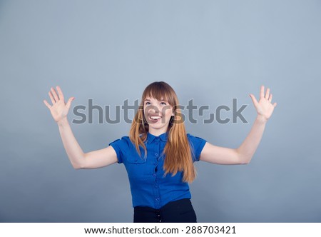 Woman holds her hands raised. Business woman raising her hands up liquefying sales, bonuses, promotions. Waiting for something to top. Concept for the poster Season of large discounts or Black Friday