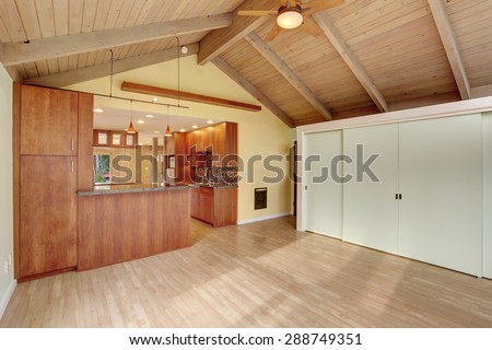 Nice dinning room with green walls and lots of light. Natural vaulted wood ceiling. Cherry kitchen with open floor plan.