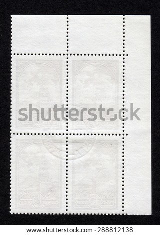 The reverse side of a postage stamp.