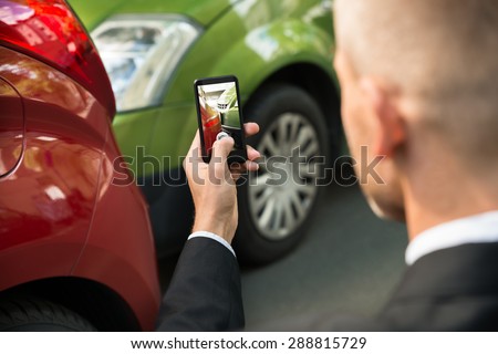 Male Driver Photographing With His Cellphone After Traffic Collision