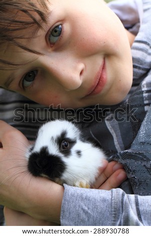 small boy and his pet rabbit are friends