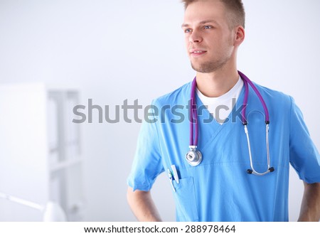 Doctor with stethoscope standing , crossed arms, isolated on white background