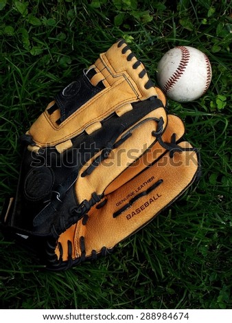 Royalty Free Photograph - Isolated Close Up Image of Leather Baseball Glove and Baseball lying on the Baseball Field