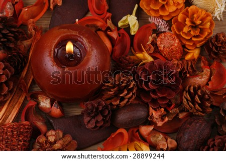 Still-life in red-orange tones with a candle