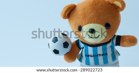 doll bear play football