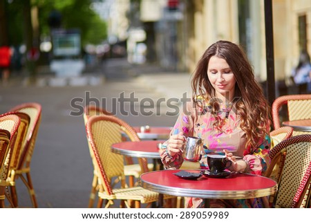 Beautiful young woman in a Parisian street cafe
