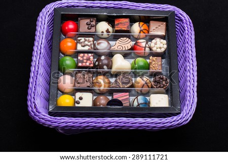 Set of a various chocolate pralines in lavender basket