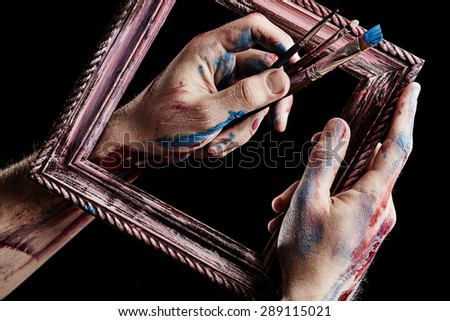 Wooden frame in hands. Conception of art