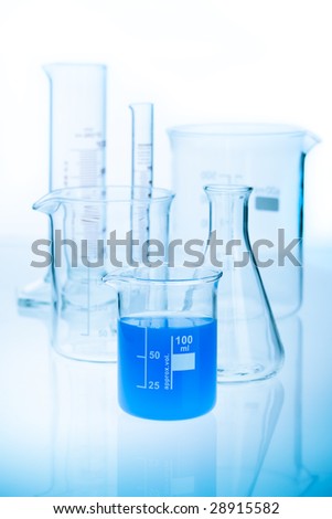 Glass chemistry set with blue liquid.