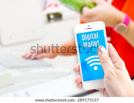 Hand holding mobile phone with digital wallet at supermarket blur background, Digital economy concept