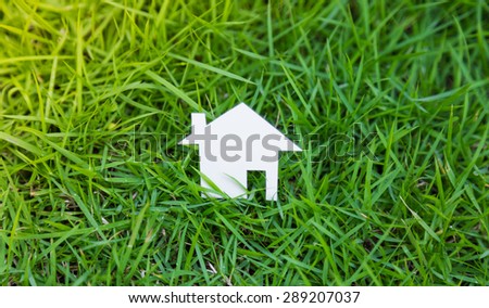 Paper cut of house fresh spring green grass