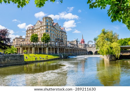 The Pulteney Bridge in Palladian style crosses the River Avon in Bath Royalty-Free Stock Photo #289211630