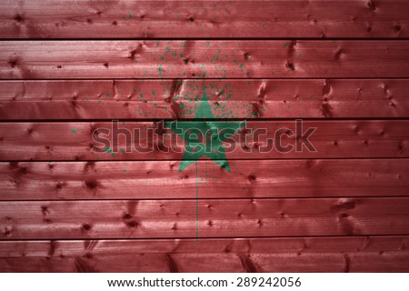 colorful painted morocco flag on a wooden texture