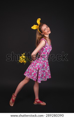 girl in studio in the dress with flowers in rabbit ears