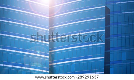 Close up of a modern business building and lens flare in blue color tone