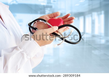 woman doctor holding a red heart