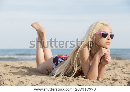 Stretched girl in a swimsuit at the beach