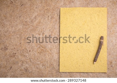Yellow Mulberry paper and pencil with copy space 