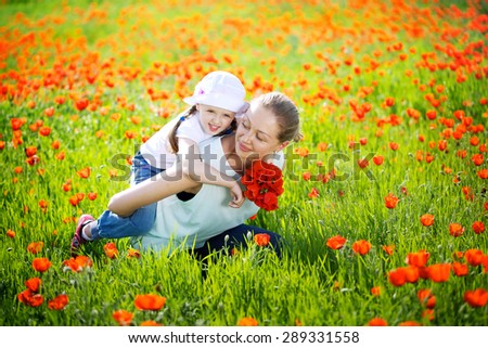 mother and daughter in a poppy field