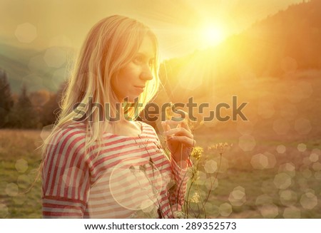 Happiness woman stay outdoor under sunlight of sunset