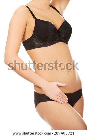 Woman in underwear touching her slim belly.