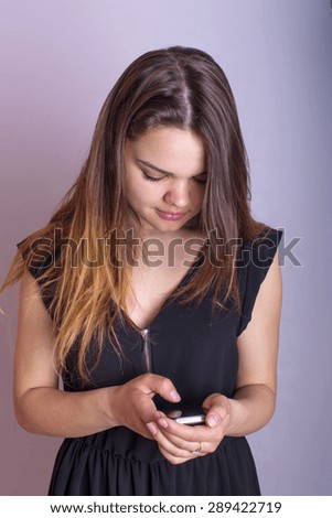young caucasian female texting on a cellphone