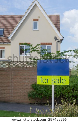 'For Sale' sign outside an English house conceptual image