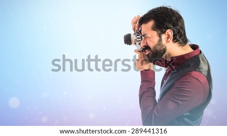 Man wearing waistcoat photographing 