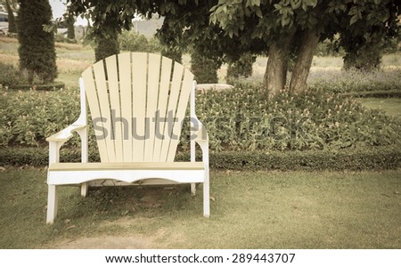 Big wooden chair in garden in vintage image