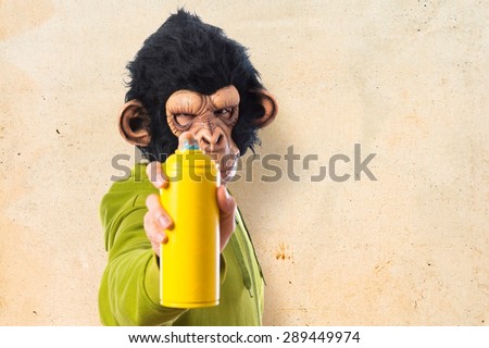 Monkey man with spray over textured background  