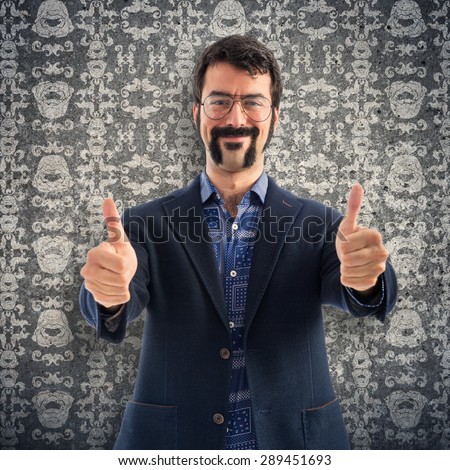 Vintage young man with thumb up over vintage background