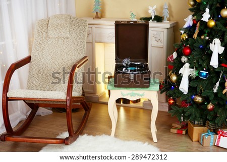 Beautiful Christmas interior with fireplace, turntable and fir tree