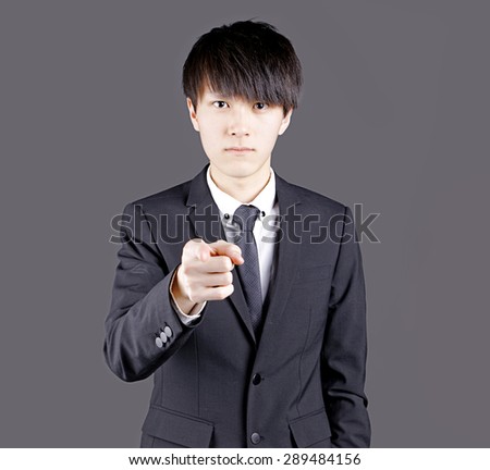 Portrait of asian man pointing with his finger
