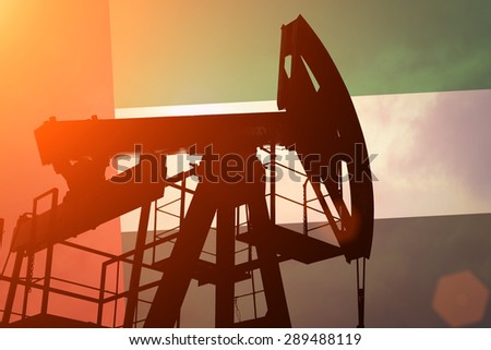 Oil pump on background of flag of Emirates