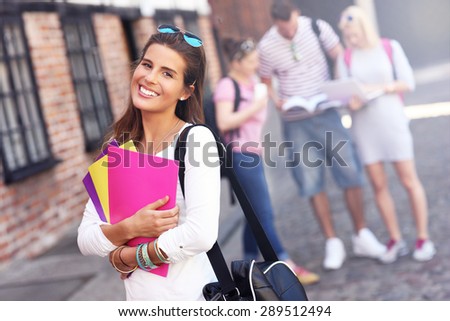 A picture of a group of happy students studying outdoors
