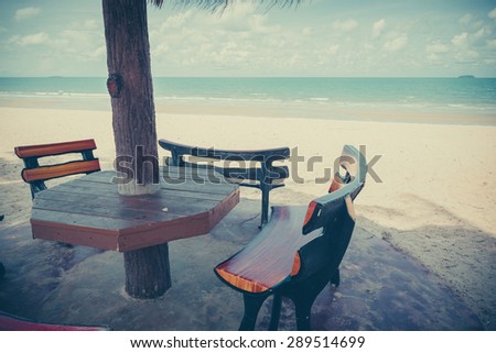 Beach chair and wooden umbrella on the beach ,Thailand - vintage effect style pictures