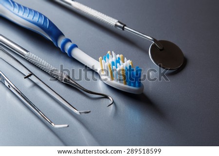 Toothbrush and dental equipment on metal surface