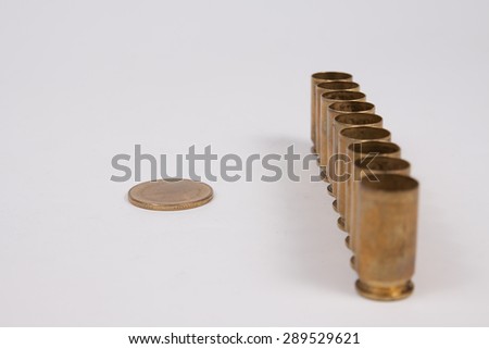 Coin thai baht and bullet shell on white background