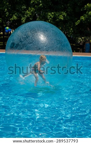 child in air bubble in swimming pool
