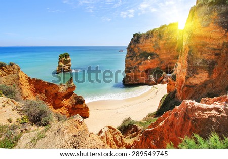 Rocky beach at sunset, Lagos, Portugal. Counter light. Travel and business background Royalty-Free Stock Photo #289549745